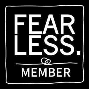 Black square with the words "FEAR LESS." in bold white letters at the top, and "MEMBER" in smaller white letters at the bottom, separated by a line with two interlocking circles.